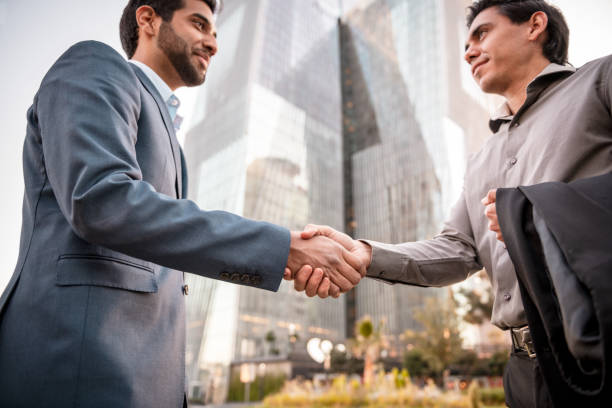 istock Entrepreneurs shaking hands at the downtown district 1219012108