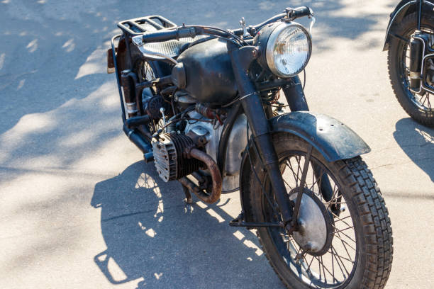 istock Old motorcycle parked on a city street 1219012418