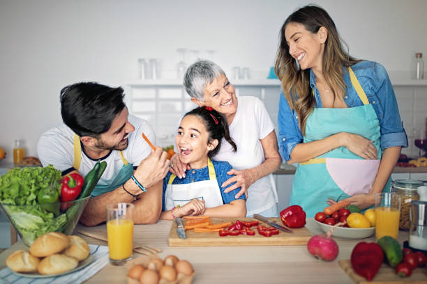 istock Happy family is cooking together in kitchen 1219013655