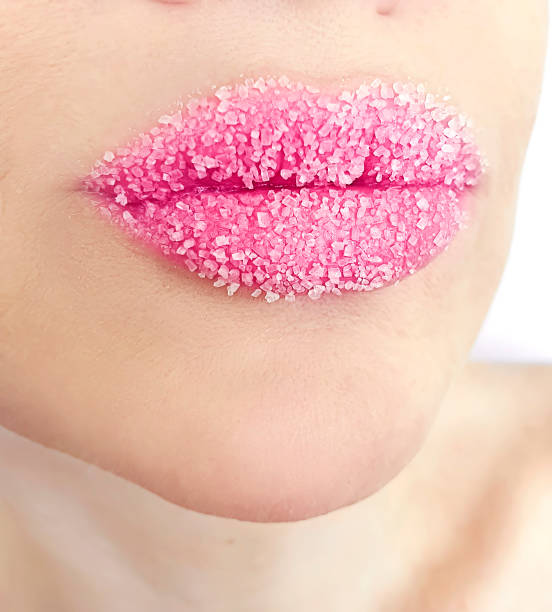 istock beautiful woman lips with sugar close-up 1219015662