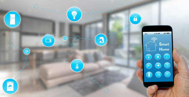 istock Hand holding smartphone with smart home application on screen 1219016147