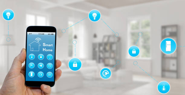 istock Hand holding smartphone with smart home application on screen 1219016150