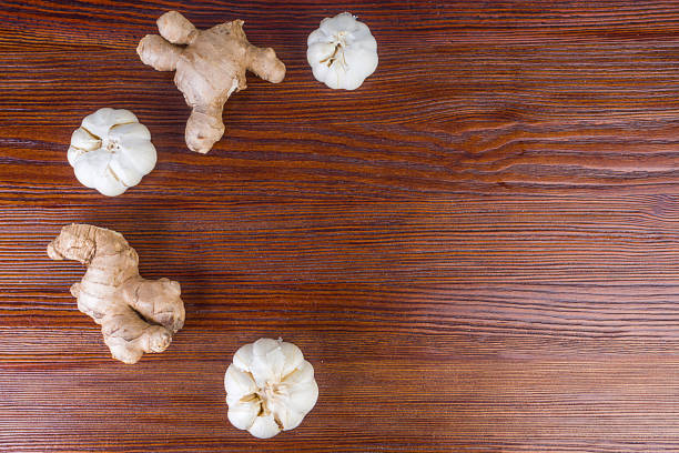 ginger and garlic on wooden background, antiviral foods, home remedies, superfood