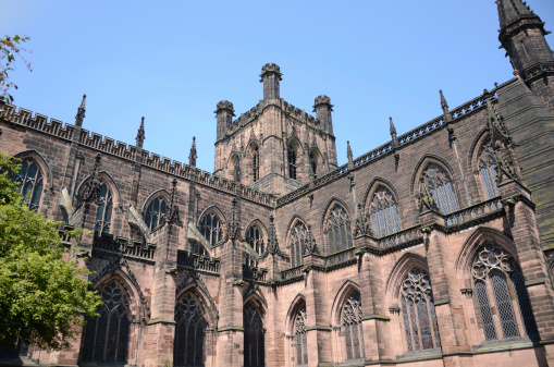 View of arches and main tower at Chester Cathedral. Image taken from in the Cathedral gardens looking up at the main halls in the bright sunlight.