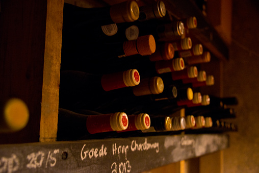 stored vintage bottles in winery cellar, stellenbosch, south africa