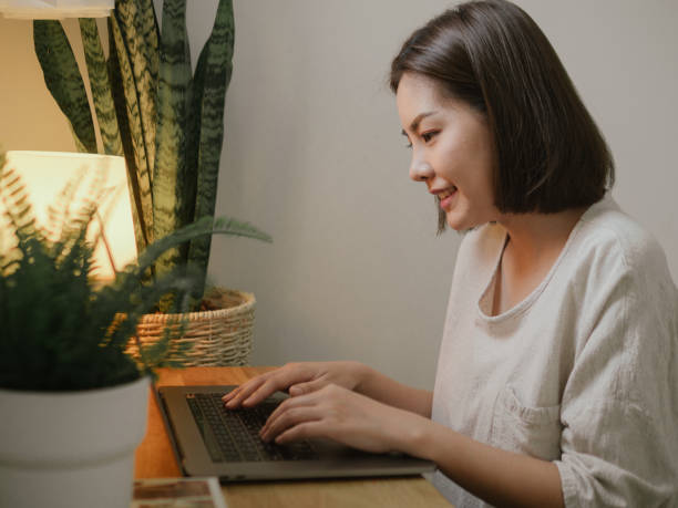 istock Asian Freelancer Woman Using Laptop in Home Garden 1219019358