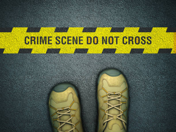 istock Feet on Asphalt Road with CRIME SCENE Cordon Tape - 3D Rendering 1219020042