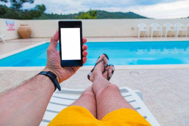 istock Man using cellphone near the swimming pool. 1219020044