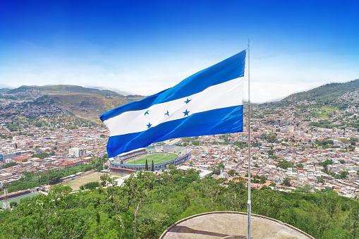 A droone photo from Cerro Juana Lainez with Honduras flag and the city of Tegucigalpa