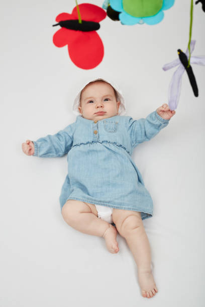 istock Happy cute baby lying on white sheet 1219020687
