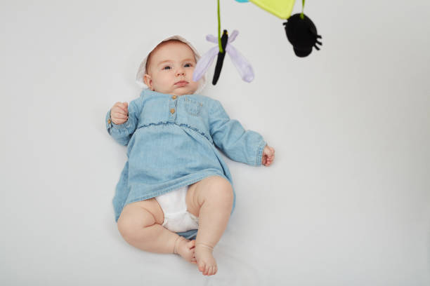 istock Happy cute baby lying on white sheet 1219020692