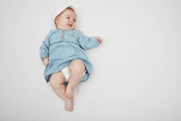 istock Happy cute baby lying on white sheet 1219020693