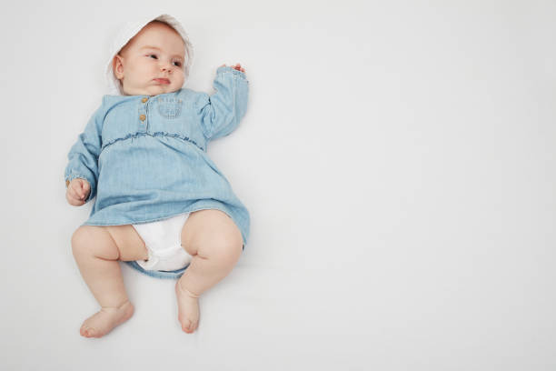 istock Happy cute baby lying on white sheet 1219020694
