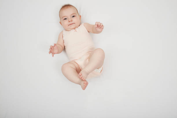 istock Happy cute baby lying on white sheet 1219020709