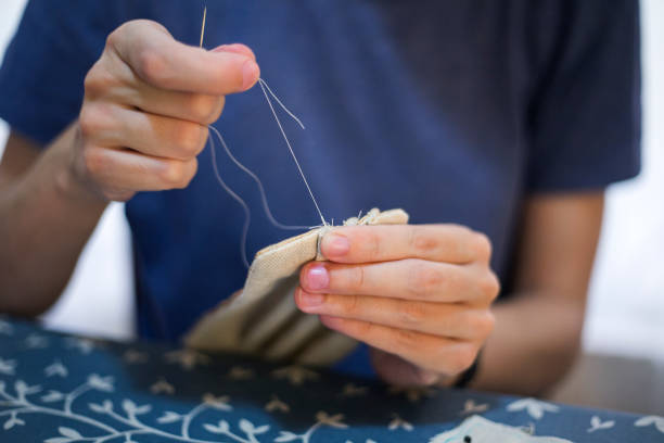 istock Woman sewing bed covers 1219022029