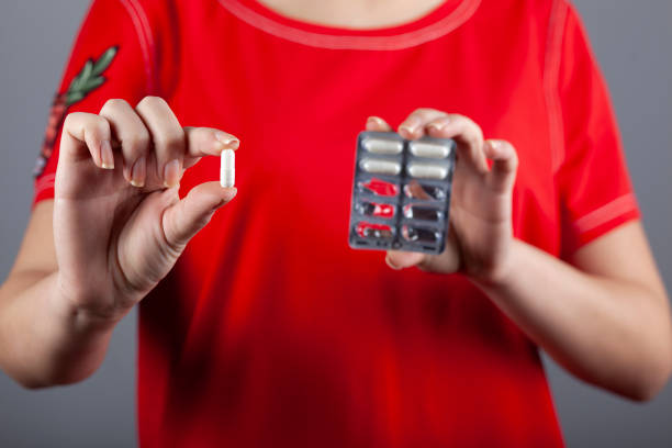istock woman hand pills 1219023893