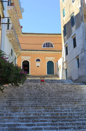 Stairway to church with red chair, Corfu town, Corfu island, Ionian Sea coast, Greece