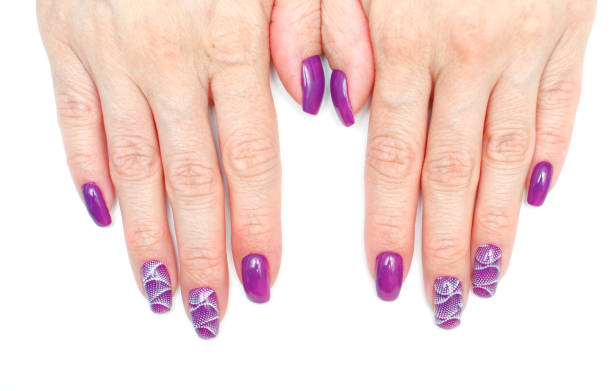 istock female fingers with painted nails. lilac nails with a pattern. 1219024190