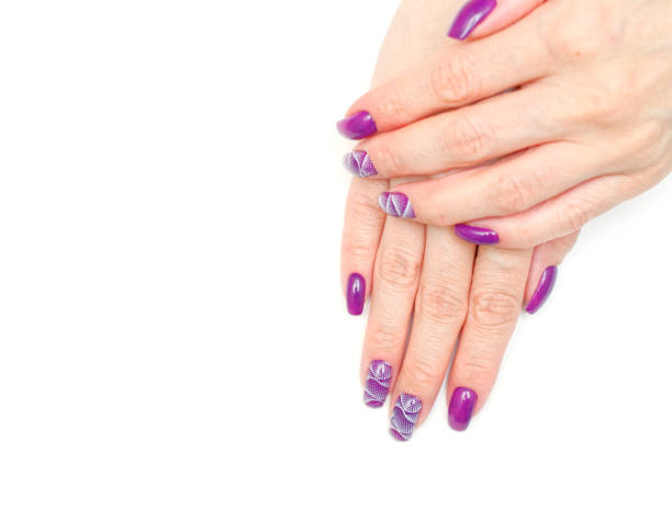 istock female fingers with painted nails. lilac nails with a pattern. 1219024191