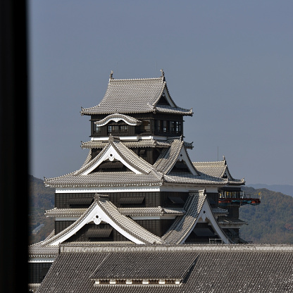 Kumamoto Castle on a sunny autumn day. It is located on a hilltop in the heart of Kumamoto and is considered as one of the three premier castles in Japan.