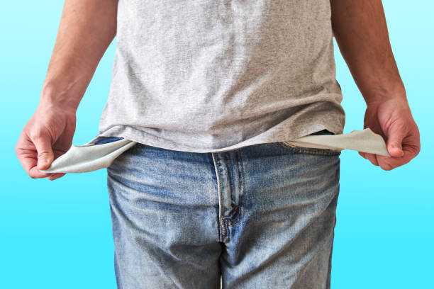 istock Inverted empty pockets. The young man turned out empty jeans pockets 1219026565