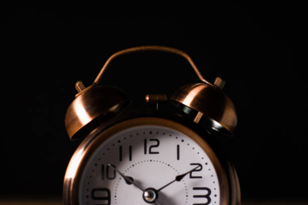istock A old vintage alarm clock bell in a brown wood table 1219026652
