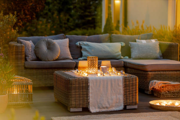 Evening on a terrace Evening on a modern designed cozy terrace with sofa and coffee table garden lights candle stock pictures, royalty-free photos & images