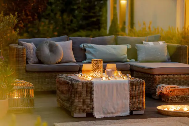 Evening on a modern designed cozy terrace with sofa and coffee table
