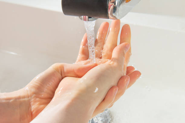 istock Washing hand palms under faucet water spray 1219029571