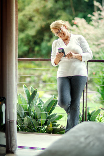 istock Woman in a conference call at home, using cell phone 1219029995