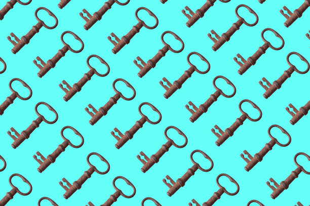 istock pattern of old rusty keys on a blue background. the key is repeated many times 1219033585