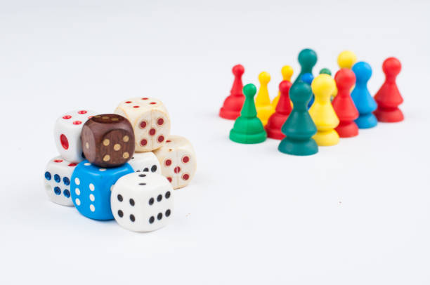 istock Colorful play figures with dice isolated on white background.Copy space. 1219034351