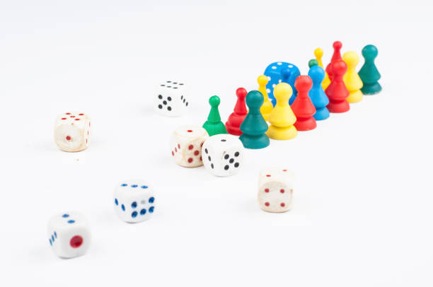 istock Colorful play figures with dice isolated on white background.Copy space. 1219034967