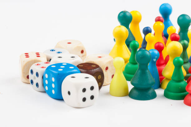 istock Colorful play figures with dice isolated on white background.Copy space. 1219035021
