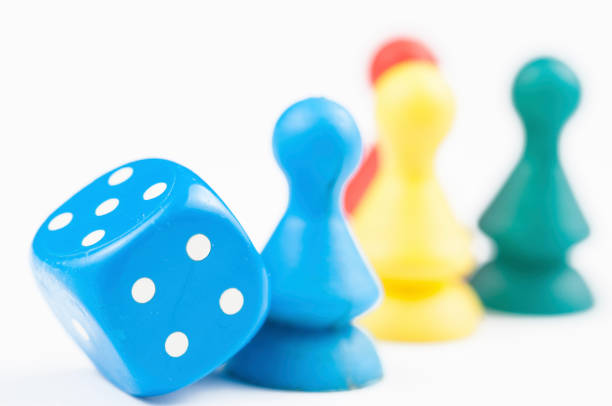 istock Colorful play figures with dice isolated on white background.Copy space. 1219035061