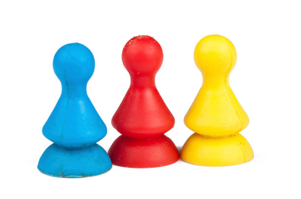 istock Colorful play figures with dice isolated on white background.Copy space. 1219035092