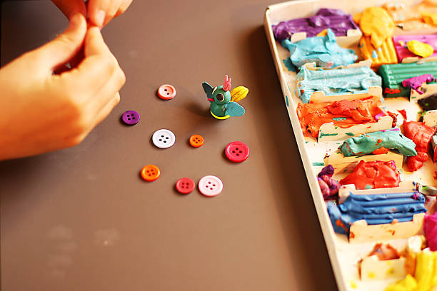 istock Children at the applique lesson cutting and pasting figures, patterns or whole pictures from pieces of paper. 1219035315