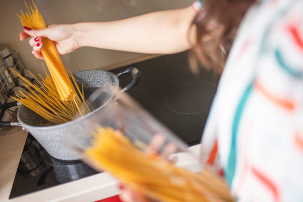 istock Unrecognizable person cooking spaghetti 1219035383