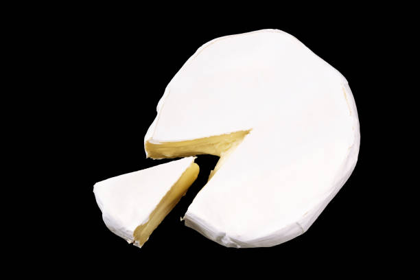 istock Camembert with slices isolated on black background. Soft cheese covered with edible white mold view from above. top view 1219036982