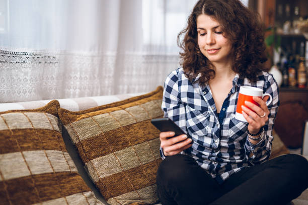 istock Relaxing with phone and cup of coffee in lockdown 1219038040