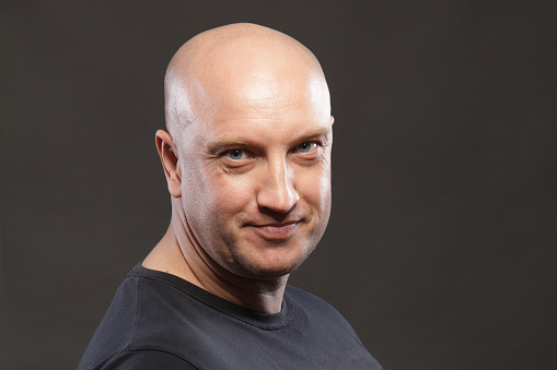 Portrait of a bald man close up smiling