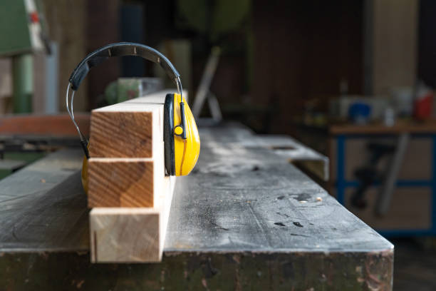 istock protective yellow headphone on wooden prism in joinery 1219038204