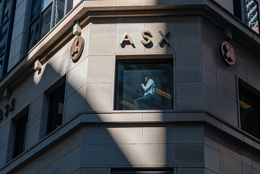 A man at the window talking on the phone at ASX Australian Securities Exchange / Sydney Stock Exchange