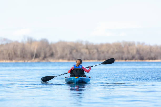istock Girl Kayaking on Lake in Early Springtime 1219047044