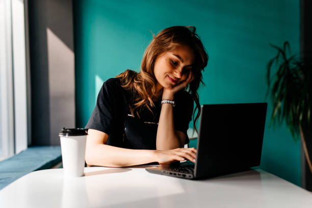istock Young woman is working on the personal computer at the cafe 1219047984