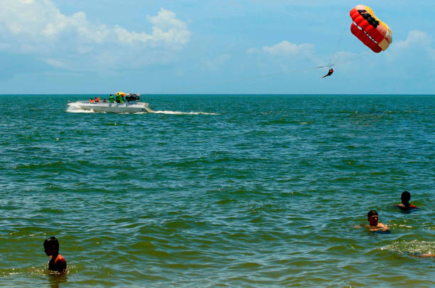 Skydiver pulled by boat over sea near Miami Beach, Florida