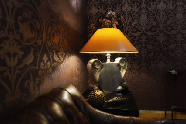 Yellow Shade, Silver Foot Lamp in Vintage Environment with Leather Sofa in Front