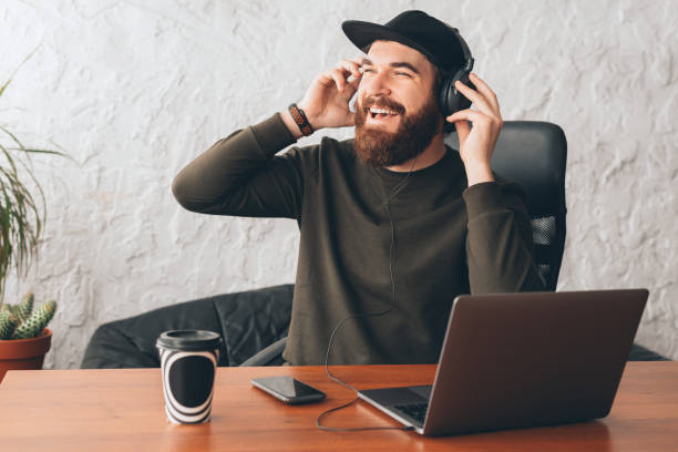 istock joyful happy man with beard listening music and relaxing in pause at work 1219050969