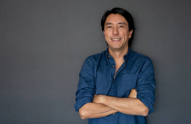 istock Happy Latin American man leaning against a wall 1219051797