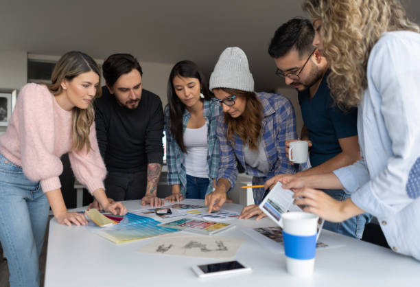 istock Team of designers sharing ideas for a project at a creative office 1219051840